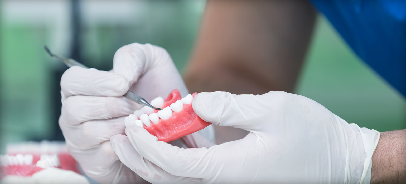 hand holding dentures